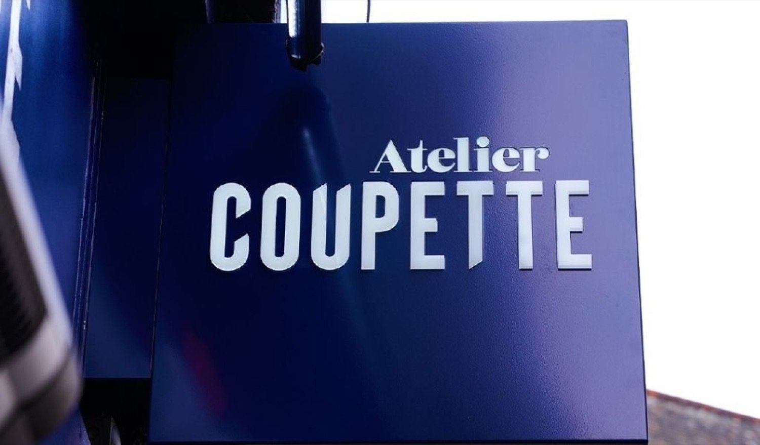 The Atelier Coupette sign above the entrance